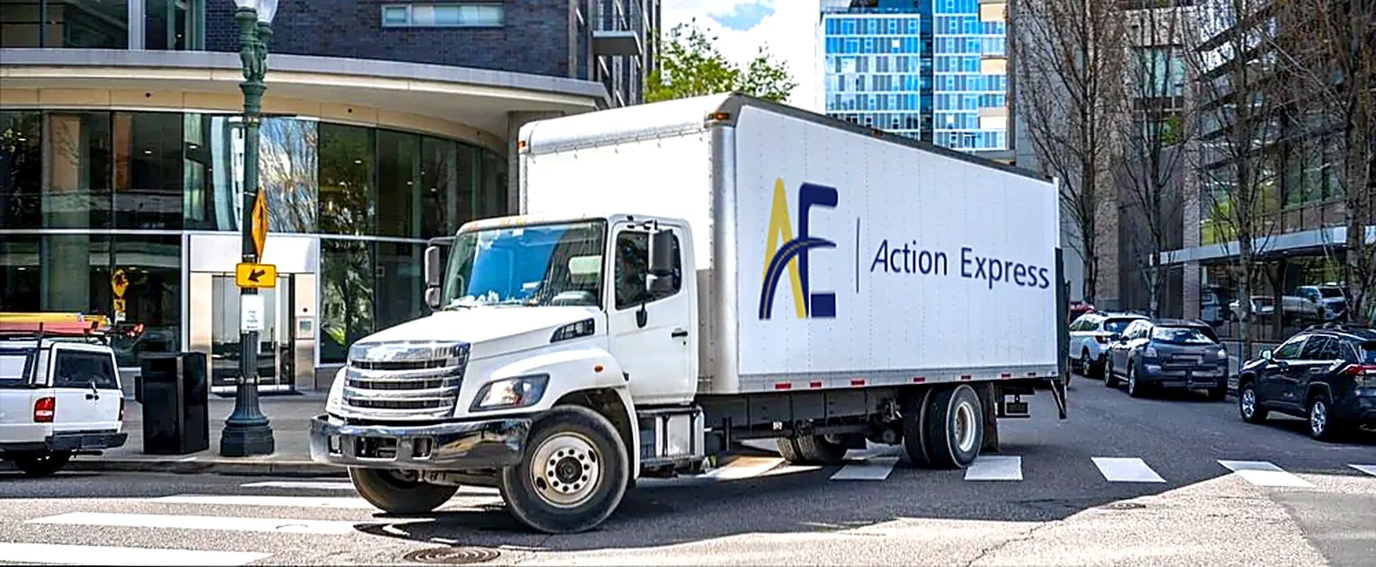 An Action Express box truck at a downtown intersection